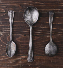 Overhead shot of rustic old spoons on wood