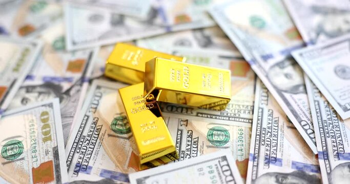Gold bars lying on set of dollar bills closeup 4k movie slow motion 
