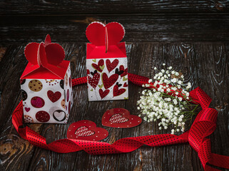 Gifts for Valentine s Day. Two festive boxes with hearts, cards, gypsophila flowers and red ribbon...