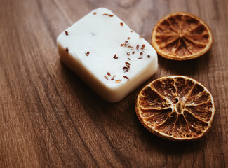 Handmade herbal soap on natural rustic wooden background, beauty hygiene and skincare product.