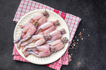 frog legs raw meat on the bone healthy meal food snack on the table copy space food background...