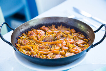 Fideua with squid and seafood. Typical Spanish tapa cooked with paella.
