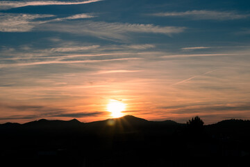 horizon between mountains with a sky with the sun dawning pink and blue