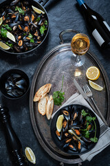 Mussels, wine and bread. Colorfully served table with seafood. Top view.