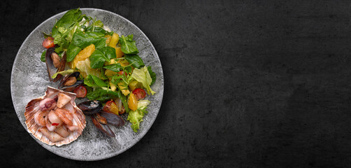 Seafood cocktail on a plate with herbs and tomatoes