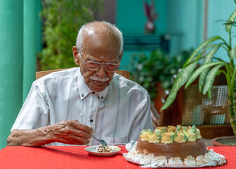 Old man eating cake