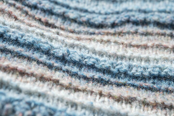 Knitted background. Knitted fabric texture, pure sheep wool, color gradient.