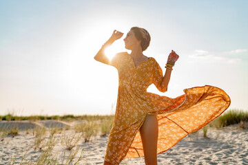 stylish attractive slim smiling woman on beach in summer style fashion trend outfit