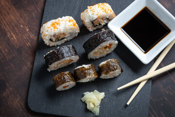 typical japanese sushi on a black slate board