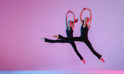?hildren dancing. Group of children, little girls in sportive style clothes dancing in choreography...