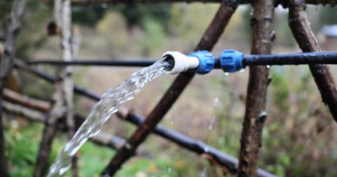 Jet of water flowing from pipe in garden 4k movie slow motion 