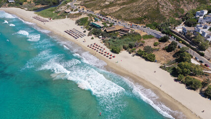 Obraz na płótnie Canvas Aerial drone photo of famous wavy beach of Mesakti ideal for wind surfing in island of Ikaria, Aegean, Greece