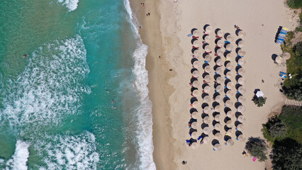 Fototapeta na wymiar Aerial drone top down photo of paradise organised sandy beach with sea beds and umbrellas in tropical exotic destination island