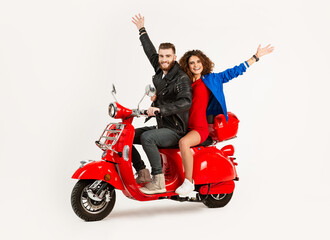 young attractive couple riding an electric motorbike scooter happy having fun together