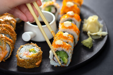 sushi rolls and sticks on table © izzetugutmen