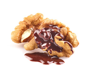 Walnuts kernel with chocolate drop in closeup on white background