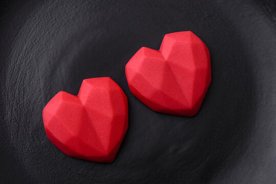 Delicious sweet heart shaped chocolate candies on a dark concrete background © chernikovatv
