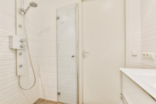 Modern shower cabin near doorway