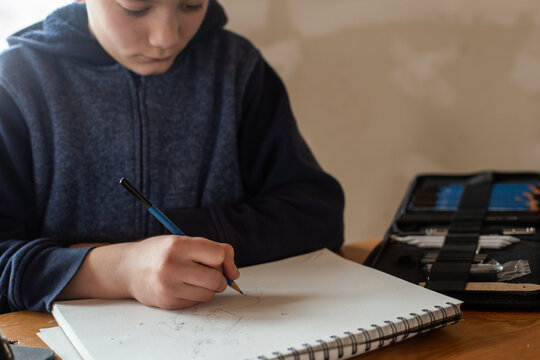 Boy drawing comics at table
