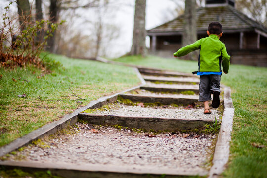 Little boy walking on outdoor steps