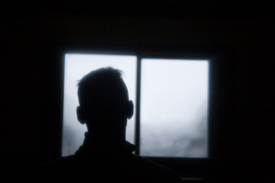 A young man relaxes in the Elfin Lakes ski hut in Garibaldi Provincial Park, British Columbia, Canada.