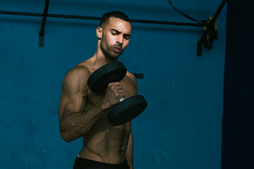 Male african american athlete with no shirt lifting weights