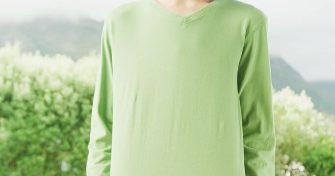 Slow motion video of african american man wearing gren long sleeve shirt with copy space