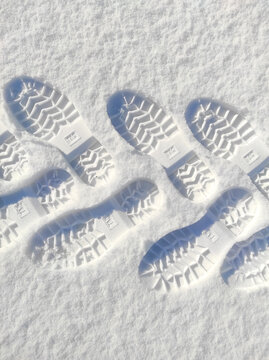 shoe prints in the snow. human feet traces in the snow. snow pathway. winter background