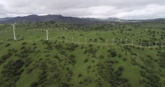 Windmills in Upper Cottonwood Creek Wildlife Area near Los Banos. California. USA. Mountains in Background