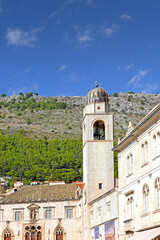 slim tower above the Dominican Monastery with classic red tiled rooftops inside the old town of Dubrovnik, Croatia
