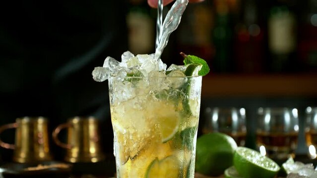 Super slow motion of making mojito cocktail with camera movement. Speed ramp effect. Filmed on high speed cinema camera with cinebot, 1000 fps.