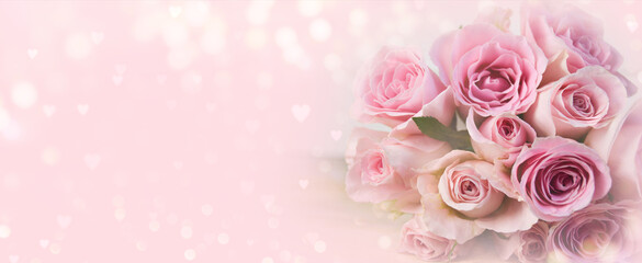 Bouquet of pink roses flowers on pastel pink bokeh background banner with hearts shape - Mother's...