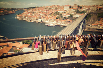 High angle view of padlocks on railing against cityscape