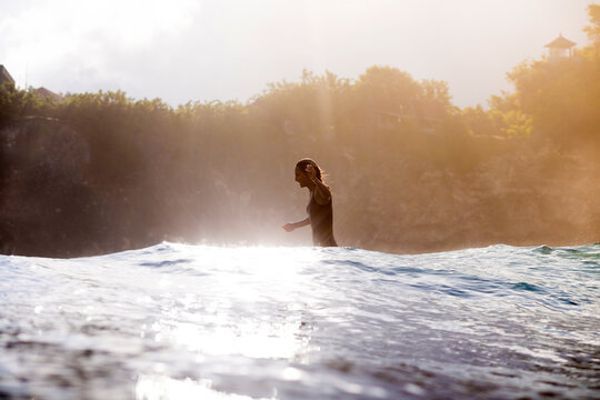 Side View Of Happy Woman Walking In Sea