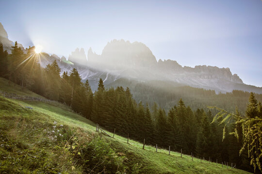 Early Morning Sun Cresting A Ridgeline In The Rosengarten Group Of The Dolomites