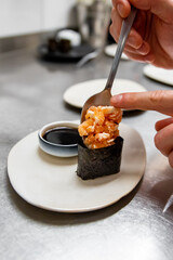 Chef's hands cooking gunkan on kitchen