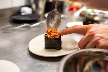 Chef's hands cooking gunkan on kitchen