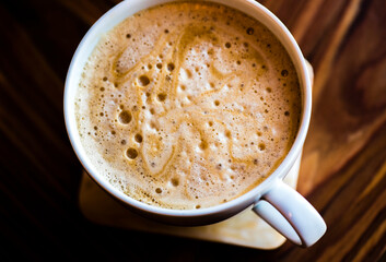 Foam on a cappuccino in a white china cup.