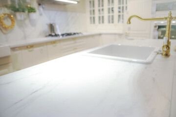 Blurred bright kitchen interior with empty countertop as a showcase for gastronomic products or foods