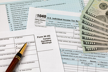 W-2G gambling income form for federal income tax return and cash money. Federal tax return, income tax and tax refund concept.