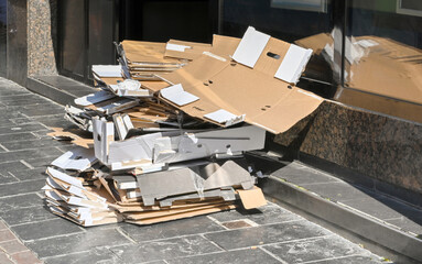 Pile of carboard on the pavement outside a fast food restaurant awaiting collection for recycling....