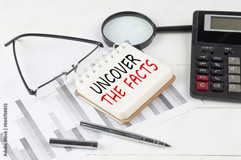 Aufkleber uncover the facts text on notebook with calculator on diagram background