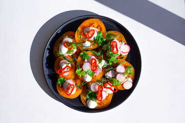 Mediterranean salad dish tomato top view with herbs and peppers