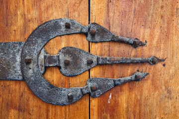 Vintage door metal hinge in the old wooden gate in Morocco.