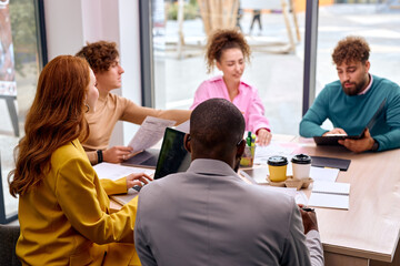 Business colleagues in modern office, planning strategy and brainstorming, colleagues thinking concept. good-looking men and women gathered together for meeting, discuss ideas and plans