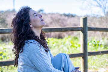 Happy Woman Breathing Deeply Fresh Air In A Field