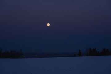 Fototapeta premium The full moon above Lake Mjøsa in winter.