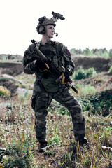 caucasian european army soldier outdoors, standing with assault rifle and machine gun, posing at...