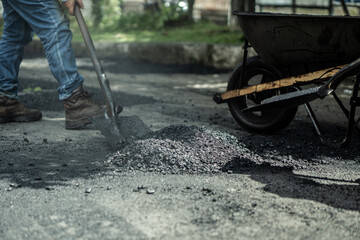 workers fixing potholes on the road