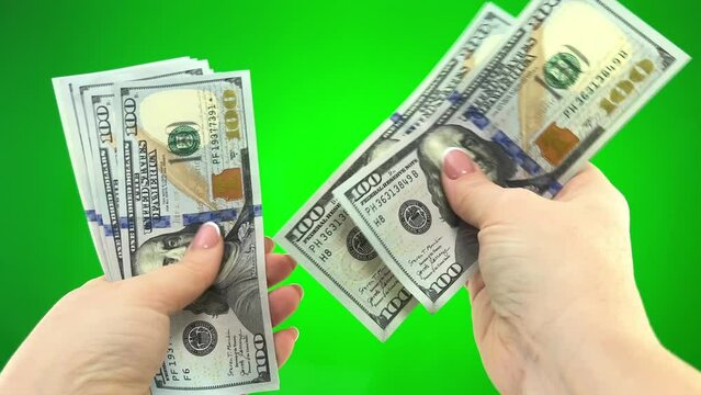  stack of 100 dollar bills on green chromakey background female hands put dollars together counting each bill and stretch forward where you can put your ad money